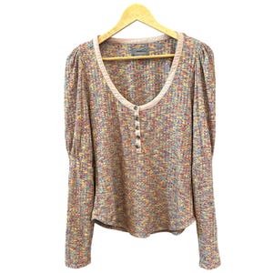 May include: A long-sleeved, multi-colored, button-up shirt with a scoop neck and a pink trim. The shirt has a speckled pattern with shades of pink, blue, yellow, and green.