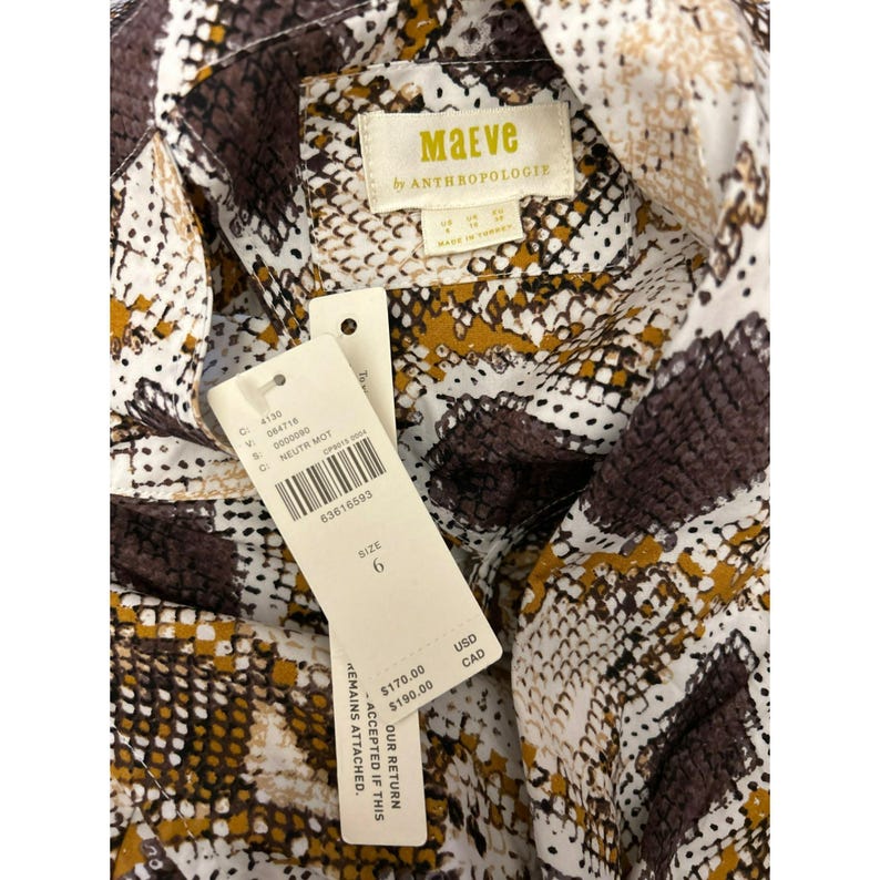 May include: A white and brown patterned shirt with a snake skin design. The shirt has a tag that says "Maeve by Anthropologie" and a size tag that says "6".
