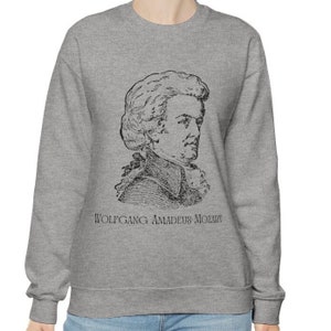 May include: A gray sweatshirt with a black and white illustration of Wolfgang Amadeus Mozart. The text "Wolfgang Amadeus Mozart" is printed below the illustration.