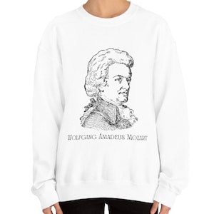 May include: White sweatshirt with a black and white illustration of Wolfgang Amadeus Mozart. The text "WOLFGANG AMADEUS MOZART" is printed below the illustration.