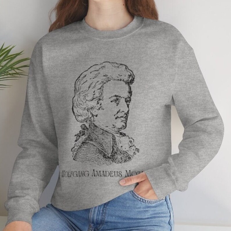 May include: A gray sweatshirt with a black and white illustration of Wolfgang Amadeus Mozart on the front.