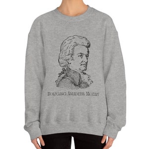 May include: A gray sweatshirt with a black and white illustration of Wolfgang Amadeus Mozart on the front. The text "Wolfgang Amadeus Mozart" is printed below the illustration.