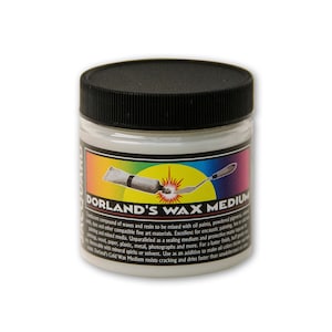May include: A white jar with a black lid labeled "Dorland's Wax Medium". The label has a rainbow background and a yellow starburst. The jar contains a white wax medium for mixing with oil paints.