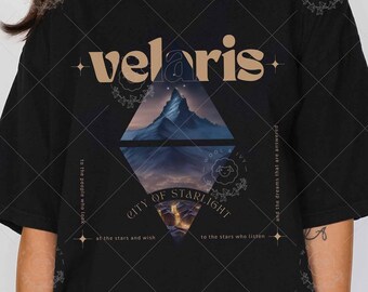 May include: Black t-shirt with a graphic design featuring a mountain range and the text "velaris city of starlight" in a gold font.