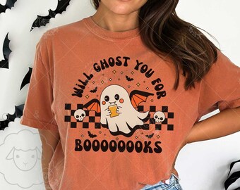 May include: Orange t-shirt with a Halloween ghost graphic. The ghost holds a drink and is surrounded by bats, skulls, and the text "Will Ghost You For BOOOOOOKS". The shirt has short sleeves and a relaxed fit.