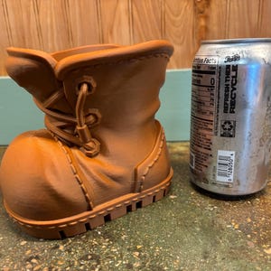 May include: A set of three ceramic mugs with a speckled, matte finish. The mugs are in shades of cream, light gray, and dark gray. Each mug has a simple, minimalist design and a rounded handle. Perfect for coffee or tea.