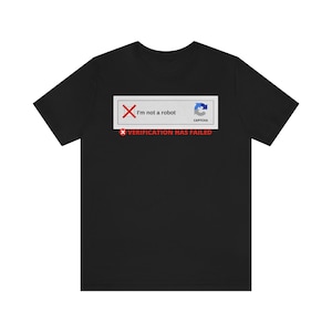 May include: Black t-shirt with a white rectangle graphic that says "I'm not a robot" with a red X and a blue CAPTCHA icon. The text "VERIFICATION HAS FAILED" is below the rectangle in red.
