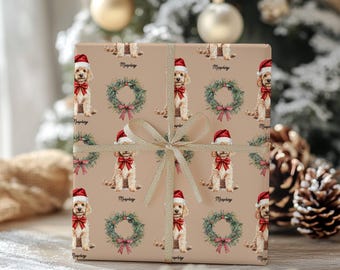 May include: Tan wrapping paper with a repeating pattern of a dog wearing a Santa hat and a red bow. The design also includes green wreaths with red bows and the name "Murphy". A gold ribbon is tied around the wrapped gift.