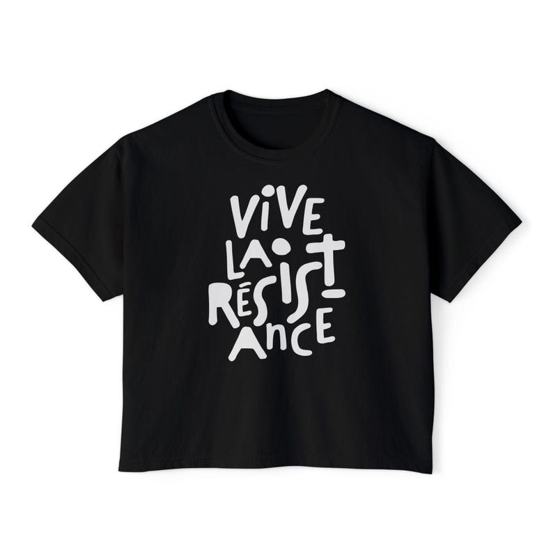 May include: Black t-shirt with the white text "VIVE LA R&Eacute;SISTANCE" in a bold, handwritten style. The shirt has a classic crew neck and short sleeves, suitable for casual wear.