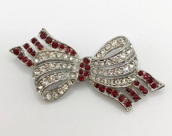 Vintage silver-tone bow brooch pin with clear and red rhinestones