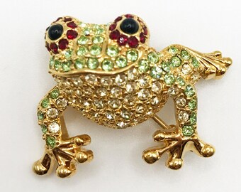 Vintage signed Monet gold-tone frog brooch pin with light green, red, and black rhinestones