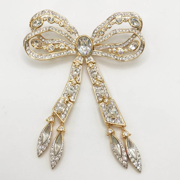 Vintage signed Nolan Miller gold tone dangle and drop bow ribbon brooch pin with clear rhinestones