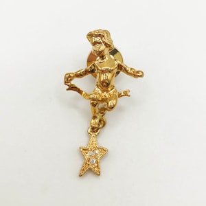 Vintage signed Kirks Folly gold tone cherub angel star pin with aurora borealis rhinestones