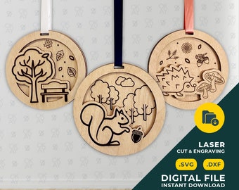 May include: Three laser cut wood ornaments with autumn themes. The first ornament features a tree with a bench, the second ornament features a squirrel in a forest, and the third ornament features a hedgehog with mushrooms.