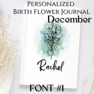 May include: A personalised birth flower journal for December with a watercolour background and a stylised floral design. The name Rachel is written in a cursive font. The journal cover also includes the text "FONT #1".