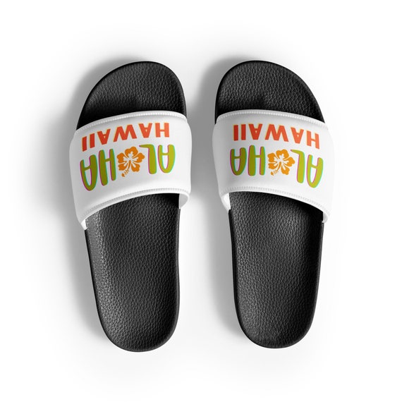 Beach lifestyle aloha sandals worn on tropical sand with ocean waves in background