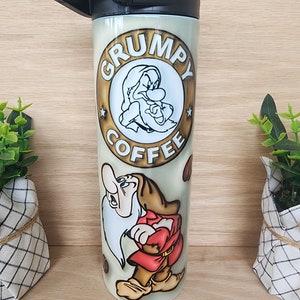 Tumbler/cup. Grumpy from snow white cartoon. With coffee lettering and coffee beans w puffy/3D look background. 20oz insulated tumbler.
