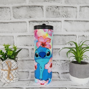 Tumbler/cup. Stitch from Lilo and Stitch design. With hibiscus flowers and very colorful background. 20oz skinny tumbler. image 1