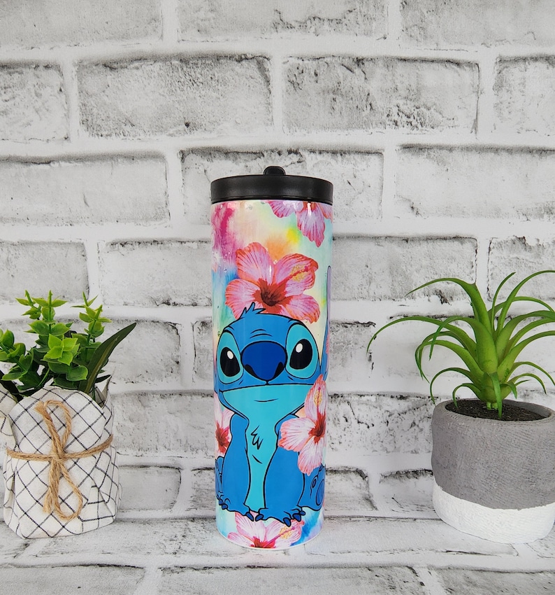 Tumbler/cup. Stitch from Lilo and Stitch design. With hibiscus flowers and very colorful background. 20oz skinny tumbler. image 1