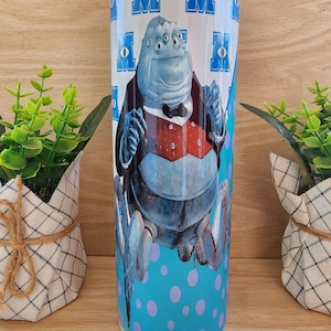 Tumbler/cup. 20oz skinny tumbler. Monsters Inc. With Henry J. Waternoose iii. Monster Inc. character. Teal with purple polka-dots background