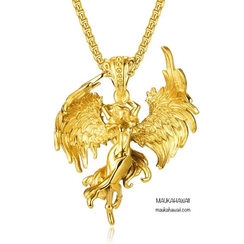 May include: A gold-toned necklace with a pendant featuring a detailed angel with outstretched wings. The pendant is intricately designed and has a textured surface.