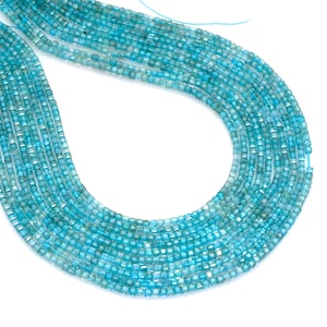 May include: Strands of small, square-cut, light blue gemstones. The beads are strung together, creating a flowing, textured appearance. The gemstones have a slightly translucent quality, and the overall effect is delicate and elegant.