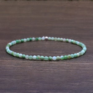 Può includere: Una delicata collana di pietre preziose verdi realizzata con piccole perle sfaccettate. La collana è infilata su una catena d'argento e misura circa 45 cm di lunghezza.