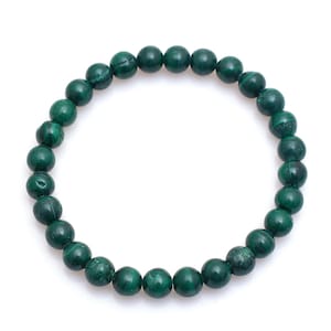 May include: A dark green malachite beaded bracelet. The bracelet is made of round, polished beads with a swirling pattern. The beads are strung together on an elastic band, creating a circular shape.