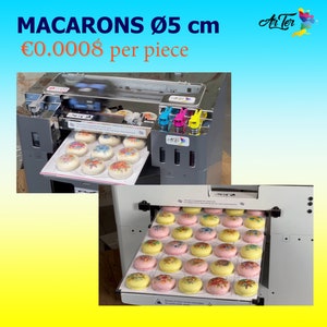May include: A machine prints edible designs onto macarons. The macarons are arranged on a tray and are being printed with colorful floral designs. The machine is labeled "Art-Ter". The text "MACARONS &Oslash; 5 cm &euro;0.0008 per piece" is displayed above the machine.