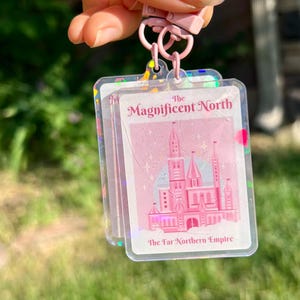 Keychain Once Upon A Broken Heart The Magnificent North Keychain Double Sided with pink attachment clip