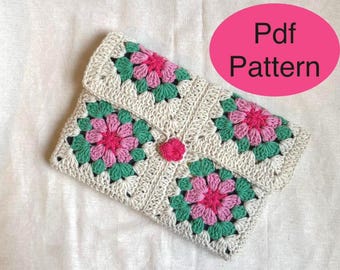 May include: A crocheted clutch with a floral design. The clutch features a beige background with pink and green flower motifs. The text "Pdf Pattern" is in a pink oval.