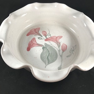 May include: White ceramic bowl with a scalloped rim and a hand-painted design of pink flowers and green leaves.