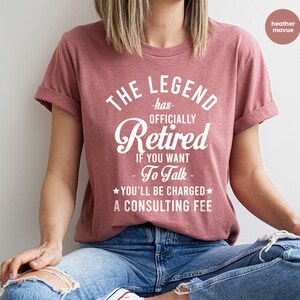a woman in a red shirt is sitting down
