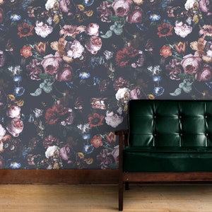 May include: A dark gray wallpaper with a floral pattern featuring a variety of pink, red, and purple flowers. A dark green leather armchair sits in front of the wallpaper.