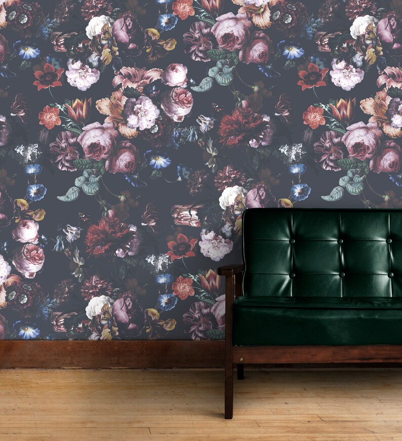 May include: A dark gray wallpaper with a floral pattern featuring a variety of pink, red, and purple flowers. A dark green leather armchair sits in front of the wallpaper.
