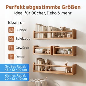 May include: Three light brown wooden wall-mounted shelves with a front safety rail. The shelves hold books, a teddy bear, a wooden toy, a cloud-shaped object, a small potted plant, and a rabbit plush. Text includes dimensions 43x12x10 cm and 20x12x10 cm.