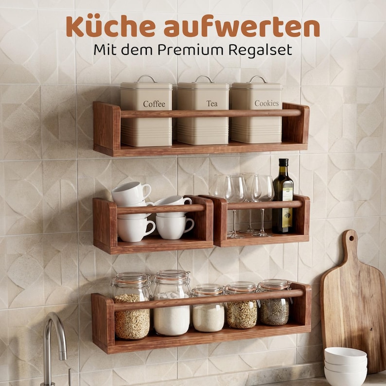 May include: Three wall-mounted wooden shelves with a horizontal bar, displaying kitchen items including three beige canisters labeled Coffee, Tea, and Cookies, white mugs, wine glasses, a bottle of oil, and glass jars filled with dry goods.