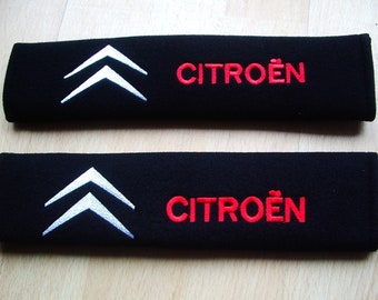 A pair of beautifully embroidered Citroen seat belt covers