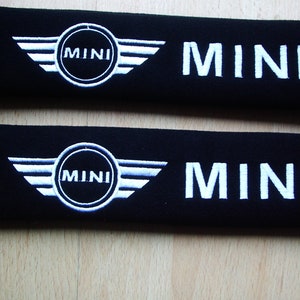 A pair of beautifully embroidered Mini seat belt covers