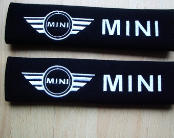 A pair of beautifully embroidered Mini seat belt covers