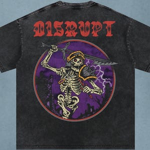 May include: Dark gray t-shirt with a distressed graphic of a skeleton warrior holding a sword inside a purple circle. The word "DISRUPT" is printed in red above the graphic. The shirt has a vintage, washed look.