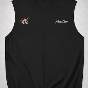 Op de afbeelding: Zwart mouwloos shirt met een schedel- en dolk-afbeelding op de linkerbovenkant. De schedel is omgeven door vlammen. De tekst "Slayer Division" is in cursieve letters op de rechterbovenkant gedrukt.