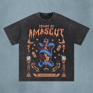 May include: A charcoal gray acid-wash t-shirt featuring a graphic print with the text "TOMBS OF AMASCUT" and "OSMUMTEN'S FANG". The design includes a blue snake coiled around a sword, surrounded by floating coins, chains, and two pillars with orbs.