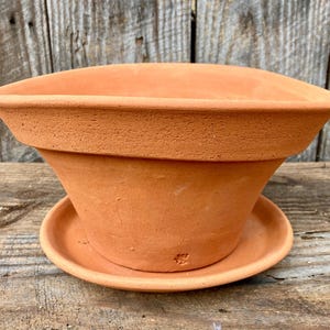 May include: A white ceramic mug with a black handle and the text "But First, Coffee" in a black, bold font. The mug is sitting on a white surface.