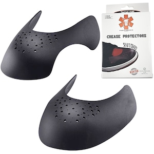 May include: Two black shoe crease protectors made of a flexible material with a perforated design. The protectors are designed to prevent creases from forming on the front of shoes. The packaging shows the product name "Crease Protectors" and the brand "Para-Medics".