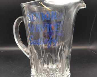A large glass Senior service jug