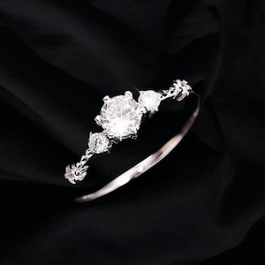 May include: A silver bangle bracelet with a large clear rhinestone and smaller rhinestones set in a delicate design.