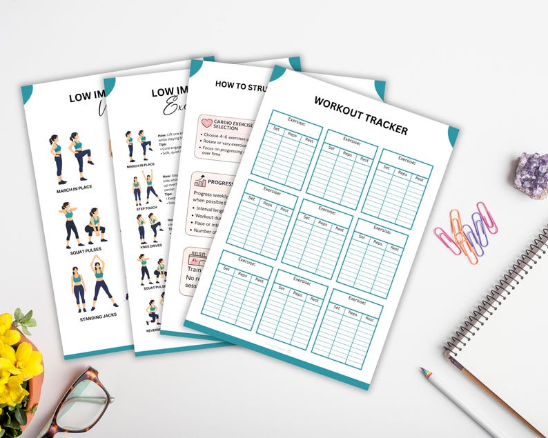 May include: A collection of white exercise trackers and guides with teal accents. The guides feature illustrations of exercises and text, including "LOW IMPACT EXERCISE" and "HOW TO STRU". A spiral notebook, pencil, and paperclips are also visible.