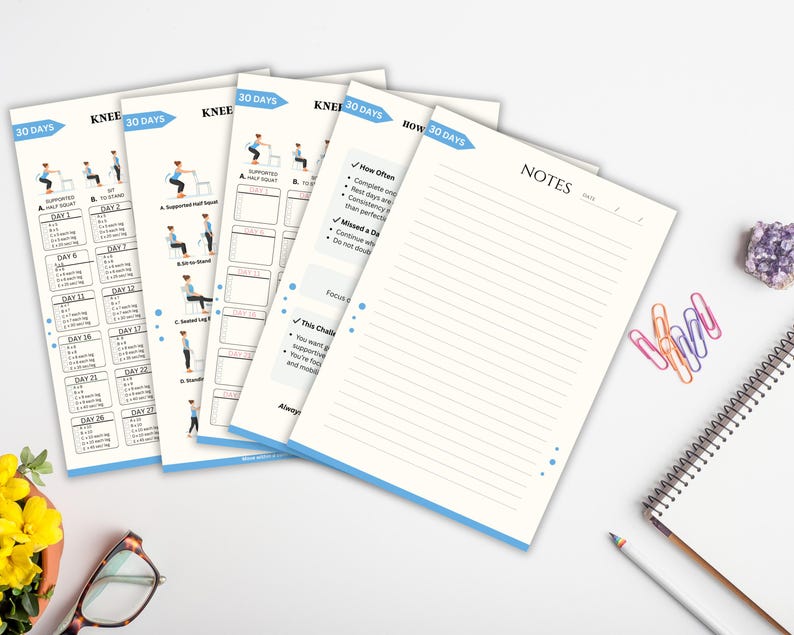 May include: Several white exercise plan sheets with blue detailing, illustrating a 30-day knee exercise program. A lined notepad, spiral-bound notebook, and colourful paperclips are also visible.