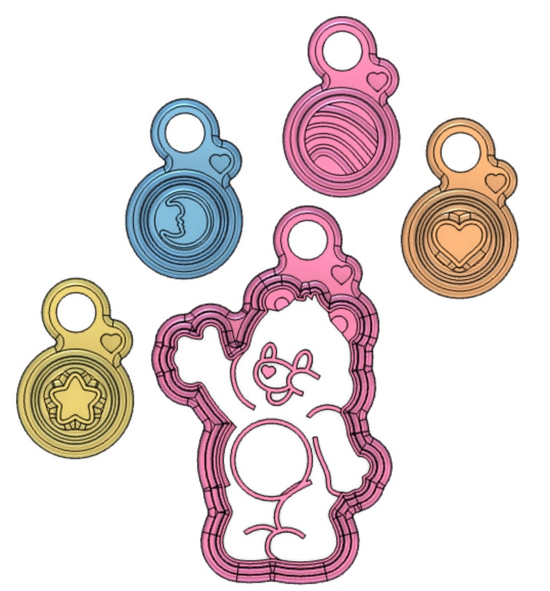 May include: Five cookie cutters, one shaped like a bear, and four shaped like circles with different designs. The bear cookie cutter is pink, the circle cookie cutters are blue, pink, and yellow.